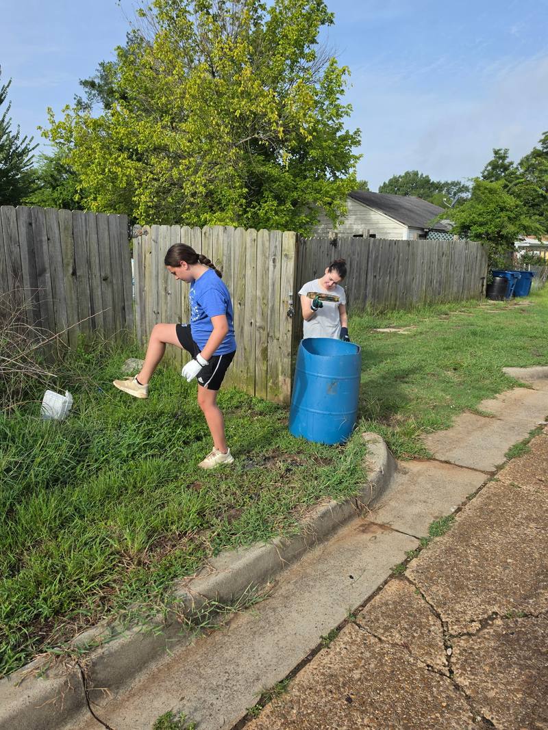 Volunteer working near the edge of the cleanup site