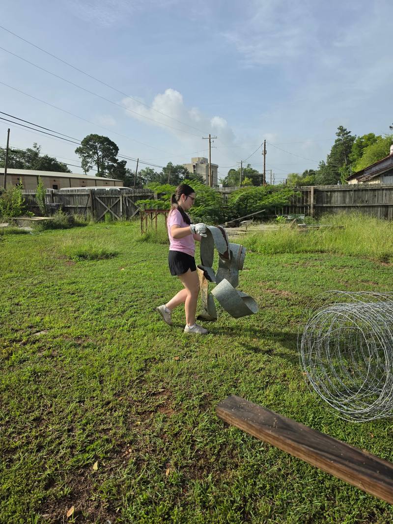 Volunteer clearing materials from the site