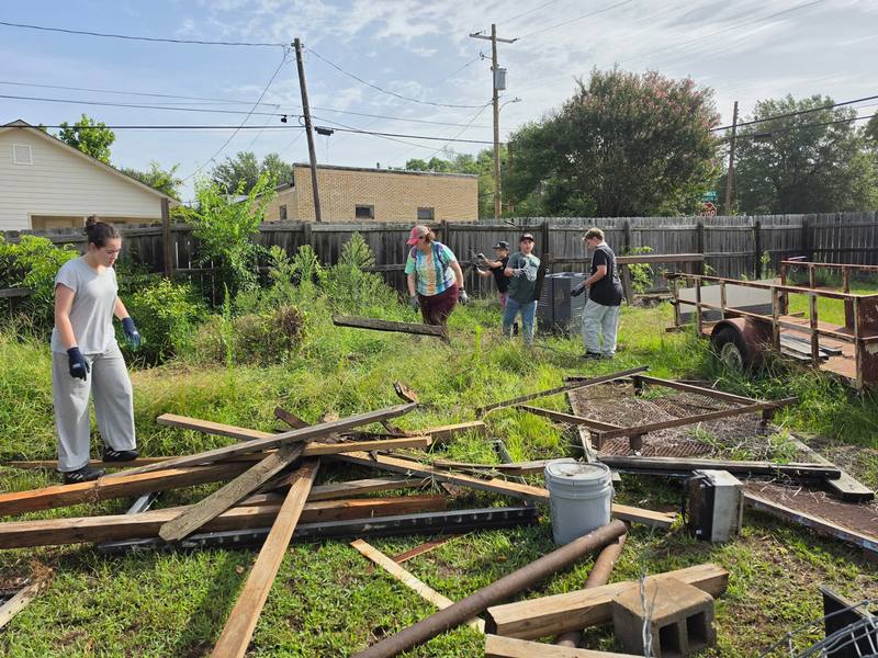 Volunteers working together near cleanup materials