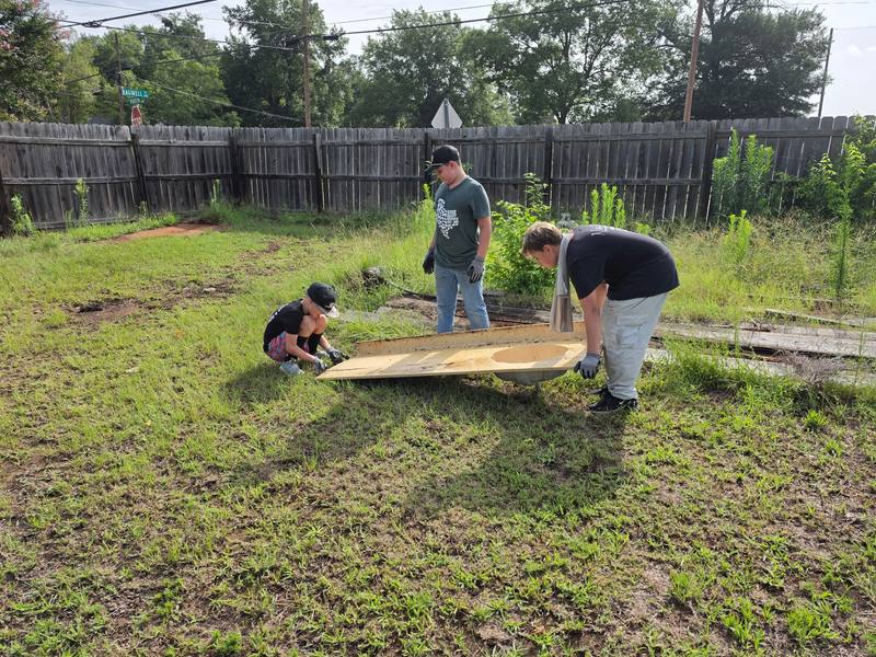 Volunteers lifting material during cleanup